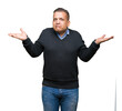 © Krakenimages.com - Handsome middle age man over isolated background clueless and confused expression with arms and hands raised. Doubt concept.