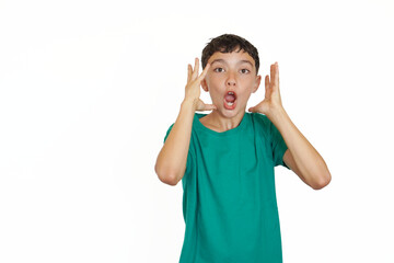 preadolescent boy on a white background with a gesture of great surprise and emotion