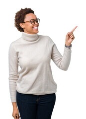 Sticker - Young beautiful african american woman wearing glasses over isolated background with a big smile on face, pointing with hand and finger to the side looking at the camera.