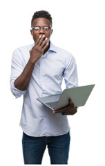 Poster - Young african american businessman using computer laptop cover mouth with hand shocked with shame for mistake, expression of fear, scared in silence, secret concept