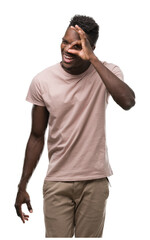 Canvas Print - Young african american man with happy face smiling doing ok sign with hand on eye looking through fingers