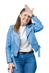 Sticker - Beautiful middle age mature woman wearing fashion leather jacket over isolated background surprised with hand on head for mistake, remember error. Forgot, bad memory concept.