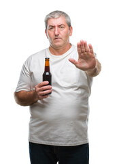 Canvas Print - Handsome senior man drinking beer bottle over isolated background with open hand doing stop sign with serious and confident expression, defense gesture