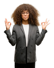 Poster - African american business woman wearing glasses relax and smiling with eyes closed doing meditation gesture with fingers. Yoga concept.