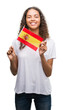© Krakenimages.com - Young hispanic woman holding flag of Spain with a happy face standing and smiling with a confident smile showing teeth