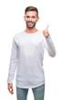 © Krakenimages.com - Young handsome man over isolated background doing happy thumbs up gesture with hand. Approving expression looking at the camera with showing success.