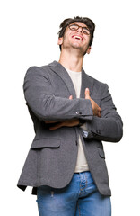 Wall Mural - Young business man wearing glasses over isolated background Smiling and laughing hard out loud because funny crazy joke. Happy expression.