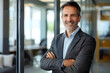 © john - smiling mid aged business man executive standing in office, mature confident professional manager, confident businessman investor looking at camera, portrait