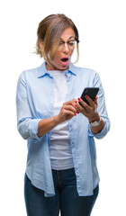 Wall Mural - middle age senior woman texting sending message using smartphone over isolated background scared in 