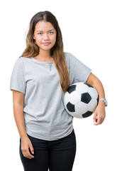 Sticker - Young beautiful brunette woman holding soccer football ball over isolated background with a confident expression on smart face thinking serious