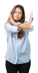 Poster - Young beautiful brunette business woman over isolated background Rejection expression crossing arms doing negative sign, angry face