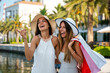 © NDABCREATIVITY - Young attractive females with shopping bags enjoying summer travel, holiday in the city.