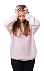 Canvas Print - Young beautiful brunette woman wearing pink winter sweater over isolated background suffering from headache desperate and stressed because pain and migraine. Hands on head.