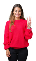 Wall Mural - Young beautiful brunette woman wearing red winter sweater over isolated background showing and pointing up with fingers number three while smiling confident and happy.