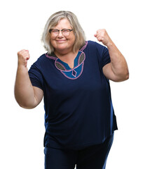 Sticker - Senior plus size caucasian woman wearing glasses over isolated background very happy and excited doing winner gesture with arms raised, smiling and screaming for success. Celebration concept.