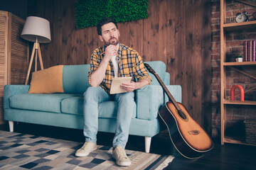 Sticker - Photo of thoughtful dreamy guy dressed checkered shirt writing songs indoors house apartment room