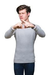 Sticker - Young handsome man wearing winter sweater over isolated background Rejection expression crossing fingers doing negative sign