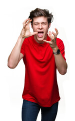 Canvas Print - Young handsome man wearing red t-shirt over isolated background Shouting frustrated with rage, hands trying to strangle, yelling mad