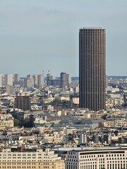 Wall Mural - Paris, France - April 12, 2024: Aerial view of Paris skyline with dense urban sprawl and modern skyscrapers, Ile de France, France.  Amazing mix between modern skyscraoers and old buildings.