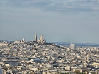 Wall Mural - Paris, France - April 12, 2024: Aerial view of Paris skyline with dense urban sprawl and modern skyscrapers, Ile de France, France.  Amazing mix between modern skyscraoers and old buildings.