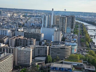 Wall Mural - Paris, France - April 12, 2024: Aerial view of Paris skyline with dense urban sprawl and modern skyscrapers, Ile de France, France.  Amazing mix between modern skyscraoers and old buildings.