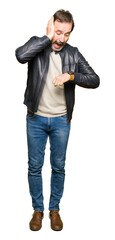 Sticker - Middle age handsome man wearing black leather jacket Looking at the watch time worried, afraid of getting late