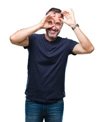 Canvas Print - Middle age hoary senior man wearing sunglasses over isolated background doing ok gesture with hand smiling, eye looking through fingers with happy face.