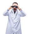 © Krakenimages.com - Middle age senior hoary doctor man looking through binoculars isolated background scared in shock with a surprise face, afraid and excited with fear expression