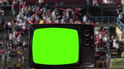 Wall Mural - antique television with green screen and blurred stadium fans in the background. you can replace gre