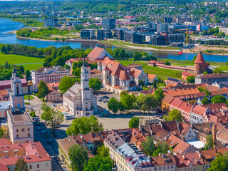 Wall Mural - Town hall and square in Kaunas old town, Lithuania. Panoramic drone aerial view photo of Kaunas city center with many old red roof houses, churches