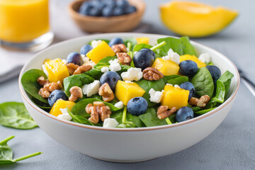 Sticker - A bowl of salad with blueberries, walnuts, and mango