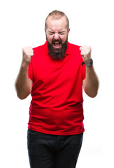 Poster - Young caucasian hipster man wearing red shirt over isolated background excited for success with arms raised celebrating victory smiling. Winner concept.