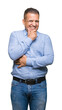 © Krakenimages.com - Middle age arab business man over isolated background looking confident at the camera with smile with crossed arms and hand raised on chin. Thinking positive.