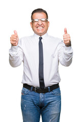 Wall Mural - Middle age bussines arab man wearing glasses over isolated background excited for success with arms raised celebrating victory smiling. Winner concept.