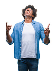 Wall Mural - afro american man over isolated background amazed and surprised looking up and pointing with fingers