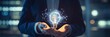 © kinara art design - Businessman holding a glowing light bulb representing innovation and creativity