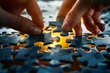 © VISUAL BACKGROUND - Two hands putting together a puzzle piece.