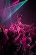 © Julie Francoeur/peopleimages.com - Crowd surf, neon and people at music festival with neon pink lighting and energy at live concert event. Dance, fun and group of excited gen z fans in arena at rock band performance or audience party.
