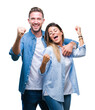 © Krakenimages.com - Young couple in love over isolated background very happy and excited doing winner gesture with arms raised, smiling and screaming for success. Celebration concept.