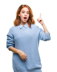 Canvas Print - Young beautiful woman over isolated background wearing winter sweater pointing finger up with successful idea. Exited and happy. Number one.