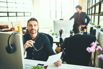 Portrait, businessman and computer in digital agency for coworking, office and brand designer. Male person, smile and technology as colleagues for teamwork, collaboration and deadline with paperwork