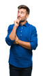 © Krakenimages.com - Young handsome man over isolated background with hand on chin thinking about question, pensive expression. Smiling with thoughtful face. Doubt concept.