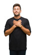 © Krakenimages.com - Young handsome man over isolated background smiling with hands on chest with closed eyes and grateful gesture on face. Health concept.