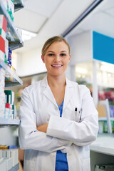 Wall Mural - Woman, confident and pharmacist portrait in pharmacy, trust and drug store or medication dispensary. Healthcare, worker and medicine retailer for career, crossed arms and professional for wellness