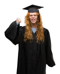 Sticker - Young redhead student woman wearing graduated uniform annoyed and frustrated shouting with anger, crazy and yelling with raised hand, anger concept