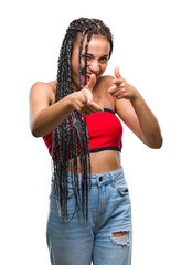 Poster - Young braided hair african american with pigmentation blemish birth mark over isolated background pointing fingers to camera with happy and funny face. Good energy and vibes.