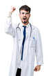 © Krakenimages.com - Young doctor man wearing hospital coat over isolated background angry and mad raising fist frustrated and furious while shouting with anger. Rage and aggressive concept.