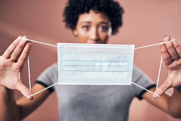 Sticker - This could save lives. Studio shot of a young woman holding up a mask.