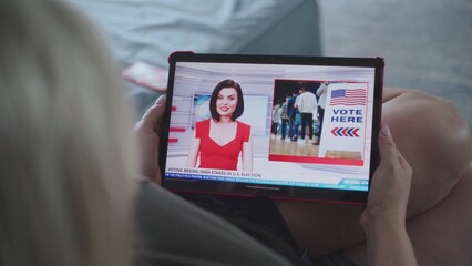 Poster - close up of tv news broadcast with female news anchor displayed on tablet screen. caucasian woman wa