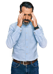 Wall Mural - Middle aged man with beard wearing business shirt with hand on head, headache because stress. suffering migraine.